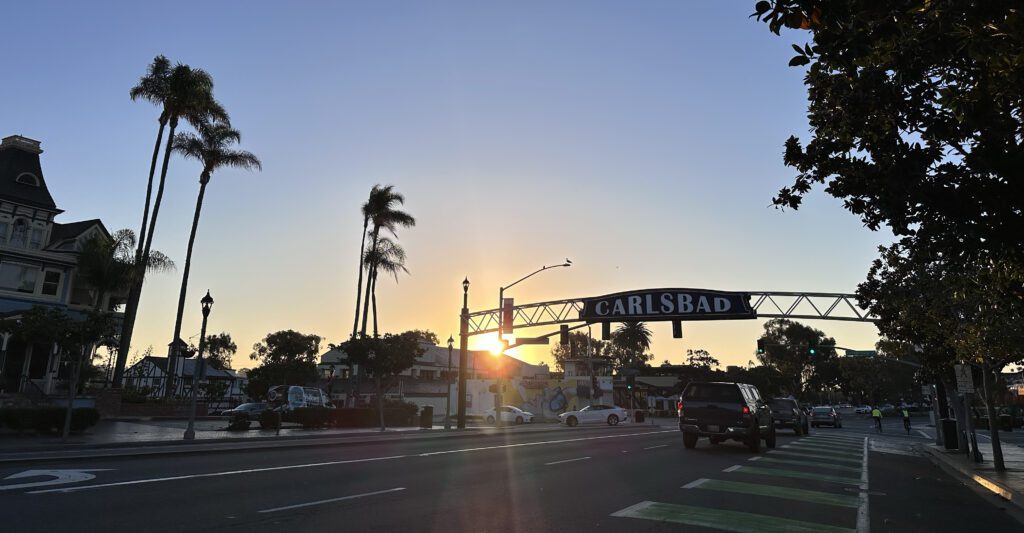 Things to do in Carlsbad, photo of the entry way sign of Carlsbad during a sunset.